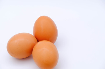 Close-up view of raw chicken eggs on background