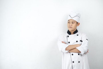 Japanese food chef in uniform crossing arms on wall.