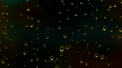 Abstract background with gold drops on glass of black window.