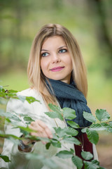 young woman standing in the green forest