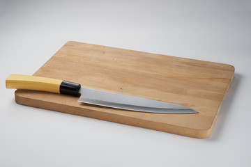 Knife on chopping board isolated over white background