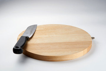Knife on chopping board isolated over white background