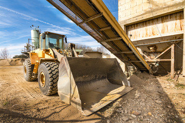 Quarry aggregate with heavy duty machinery.