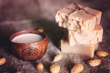 pieces of handmade soap with almond milk on burlap