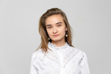 Obraz premium Beautiful young woman portrait. Studio shot, isolated on gray background