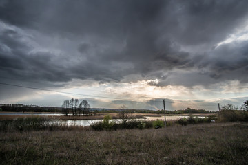 Beautiful sunset with a dark rain cloud in the foreground.
