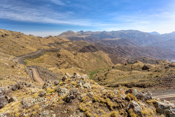 Stony winding road in beautiful Semien or Simien Mountains National Park landscape in Northern Ethiopia. Africa wilderness, Sunny morning with blue sky