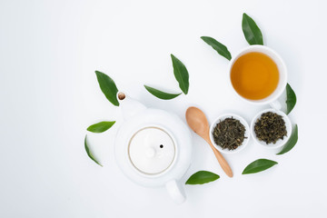 cup with tea and teapot on white background, over light
