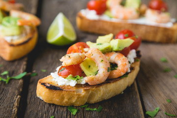 Sandwich with vegetables and prawns. Bruschetta with avocado and shrimp