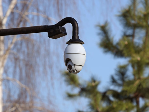 The surveillance system is located on a pole in the open. Threat to confidentiality and protection of personal data. Security tracking on the city streets. Personal privacy and social management