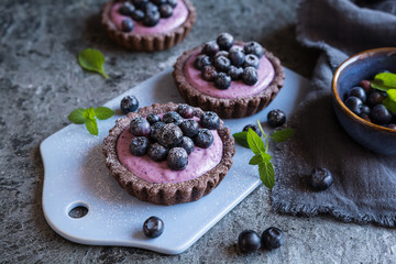 Chocolate tartlets filled with blueberry mascarpone cream