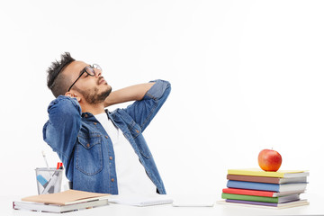 Student relaxes at the table in the cabinet after a long day.