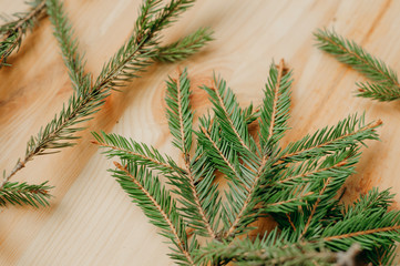 Christmas fir branches on a  wooden table.