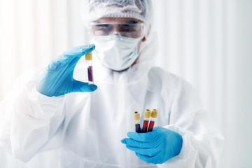 Researchers test blood samples in the laboratory. Researchers are inventing vaccines to treat COVID-19 virus.