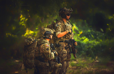 Special forces. soldier assault rifle with silencer. sniper in the forest. 