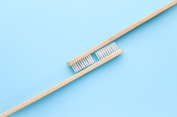 Zero waste and without plastic concept. Two eco friendly bamboo toothbrushes on a light blue surface. Top view, copy space. Layout natural organic hygiene products.