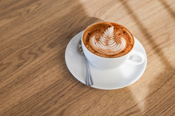 Coffee latte art on wooden table