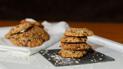 OAT AND BANANA COOKIES ON A BLACK BACKGROUND