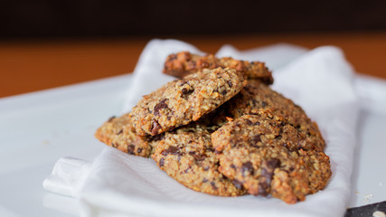 OAT AND BANANA COOKIES ON A BLACK BACKGROUND