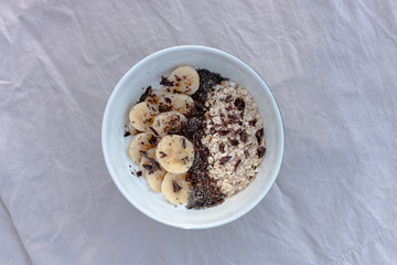 YOGURT BALL WITH BANANA OAT AND CHOCOLATE ON A WHITE BACKGROUND