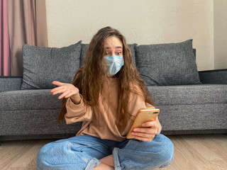 woman Working from home wears a protective medical mask. The concept of home quarantine.