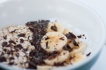 YOGURT BALL WITH BANANA OAT AND CHOCOLATE ON A WHITE BACKGROUND