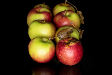 Lot of whole fresh garden apple isolated on black glass