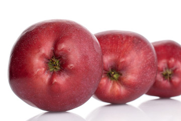 Group of three whole red delicious apple in row isolated on white