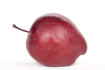 One whole red delicious apple closeup isolated on white
