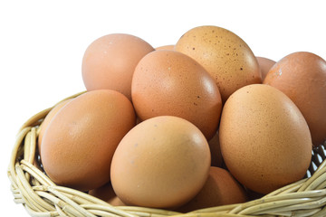 Several eggs in a rattan basket on a white background