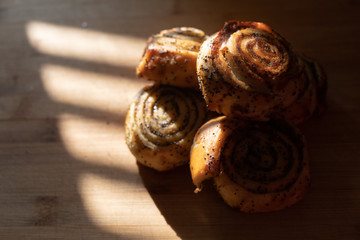 delicious bagels with poppy seeds  lie on a wooden Board, warmly illuminated by a beautiful warm light.