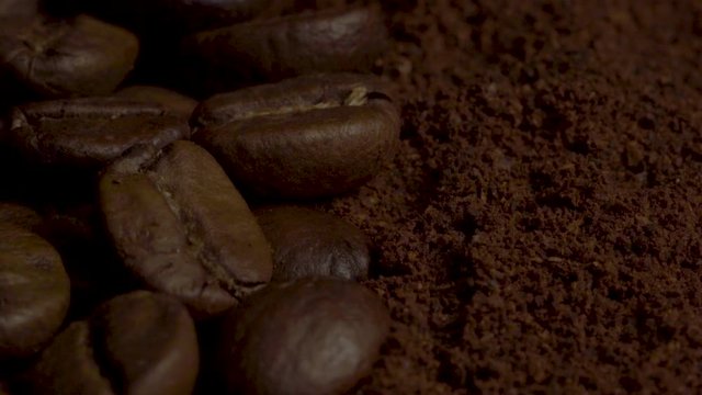 Coffee beans and ground coffee close up. 4K shot of fine ground coffee powder close up in slow motion.