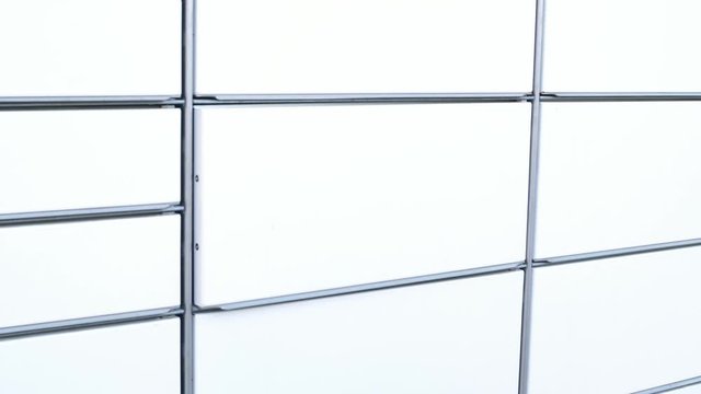 courier in mask protective gloves placing package in box in parcel locker