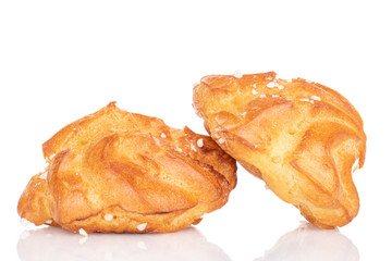Group of two whole sweet fresh baked profiterole isolated on white