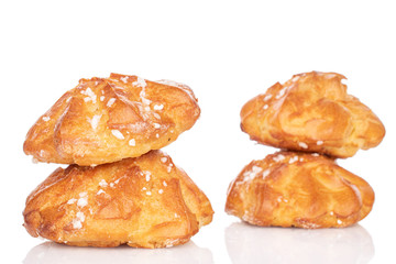 Group of four whole fresh baked profiterole isolated on white