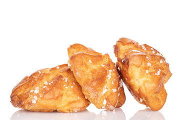 Group of three whole fresh baked profiterole in row isolated on white