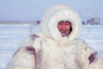 Tundra, Yamal Peninsula, far north, reindeer pasture, dwelling of northern peoples, portrait of a shaman in a white fur coat