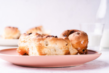 Cinnamon buns   in plate on morning table