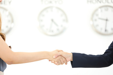 businessman and businesswoman holding clock
