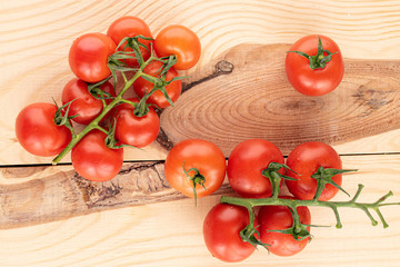 Lot of whole fresh red cherry tomato on wood