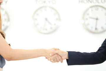businessman and businesswoman holding clock