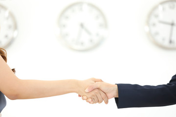 businessman and businesswoman holding clock