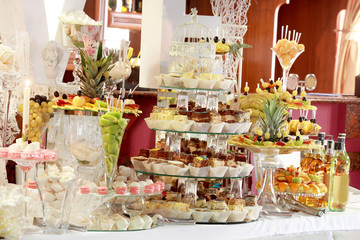 Candy bar on wedding ceremony with a lot of different candies and beverages