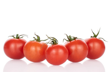 Group of five whole fresh red cherry tomato isolated on white