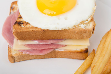 Fragment of sandwich with ham and cheese.