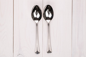 Group of two whole spoon on white wood