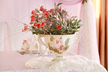 Wedding. Banquet. The chairs and round table for guests, served with cutlery, flowers and crockery and covered with a tablecloth