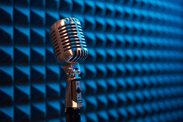 Studio retro condenser microphone on acoustic foam panel - obrazy, fototapety, plakaty
