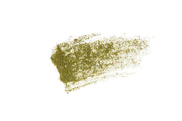 Grinded cannabis smeared on a white background.