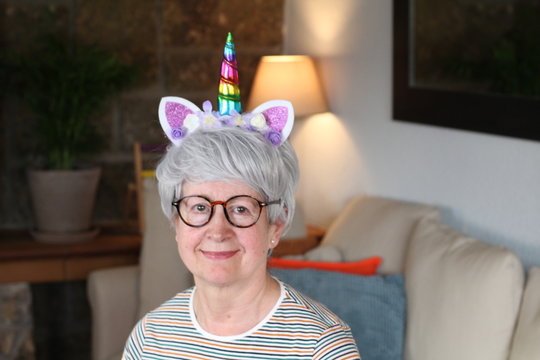 Senior Woman Wearing Unicorn Crown 